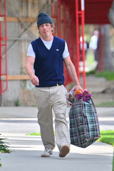 jeremy allen white holding a bag of groceries